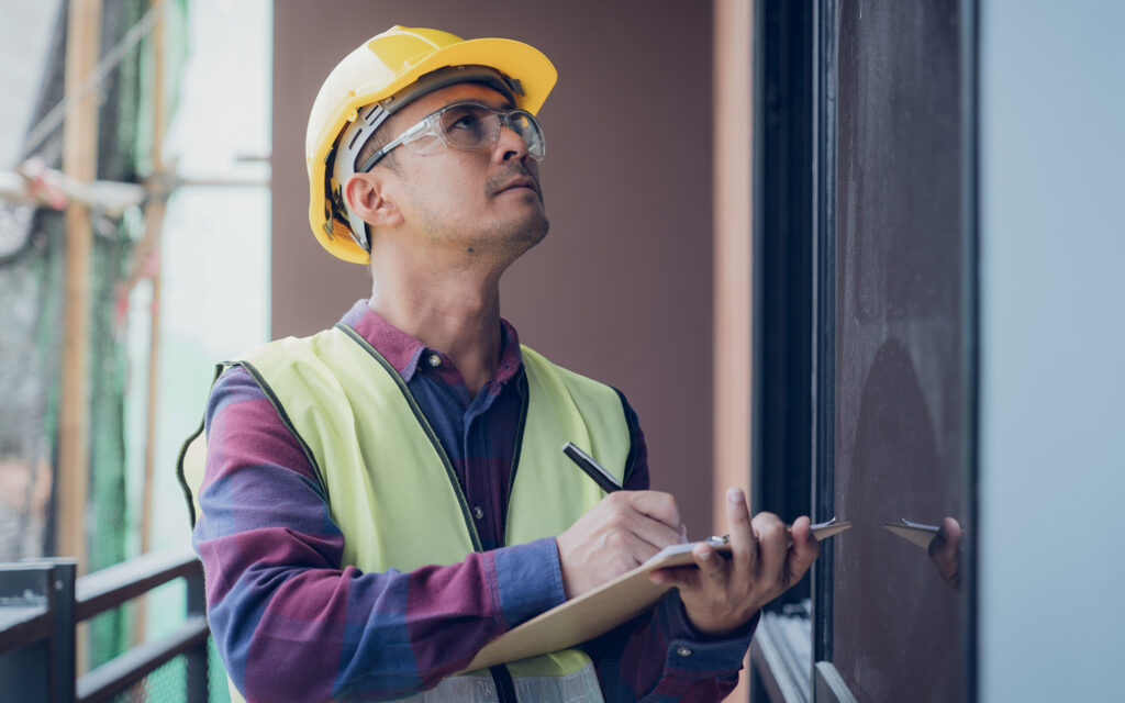 Home inspector looking up at imperfection